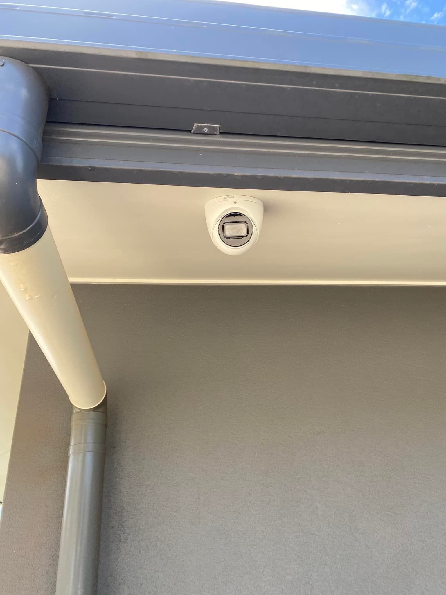 A Smoke Detector is Mounted on the Ceiling of a Building — DGC Tech Solutions In Atherton, QLD