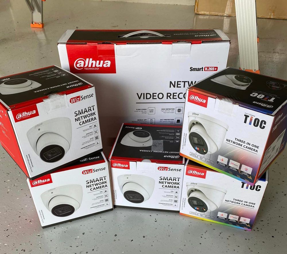 A Bunch of Boxes of Cameras Are Stacked on Top of Each Other — DGC Tech Solutions In Mareeba, QLD