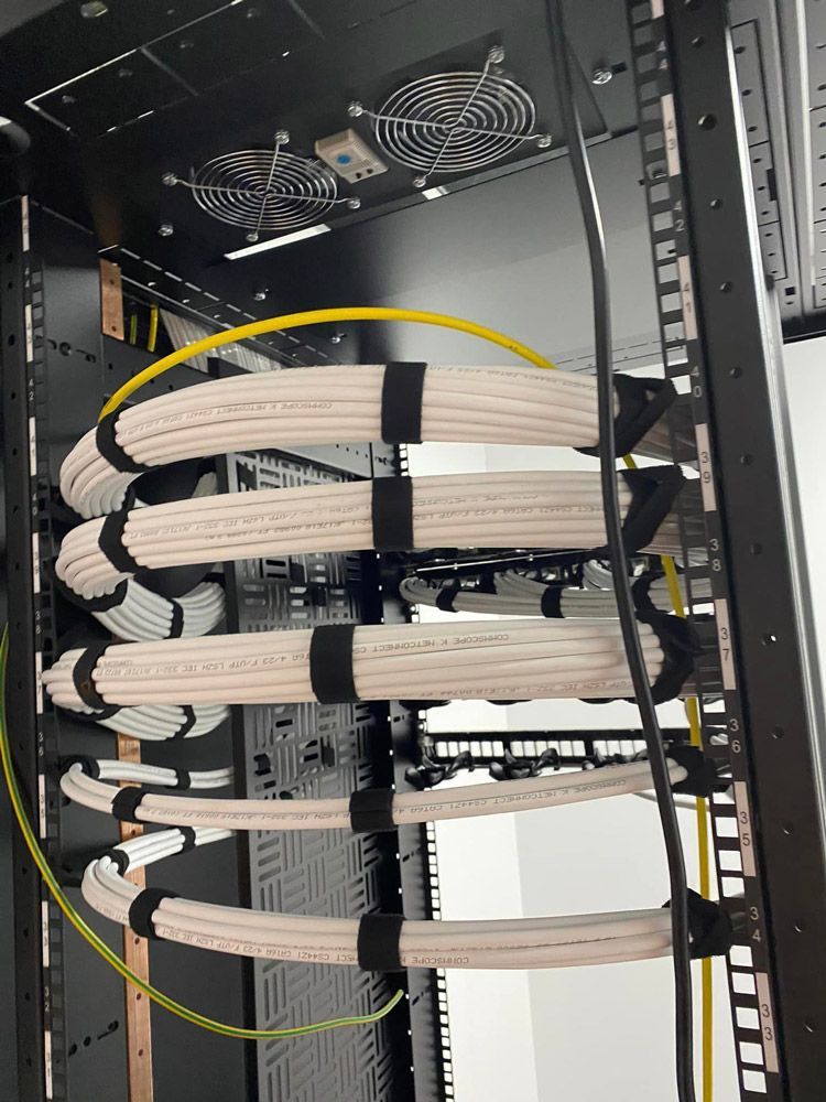 A Bunch of Wires Are Hanging From a Rack — DGC Tech Solutions In Mareeba, QLD