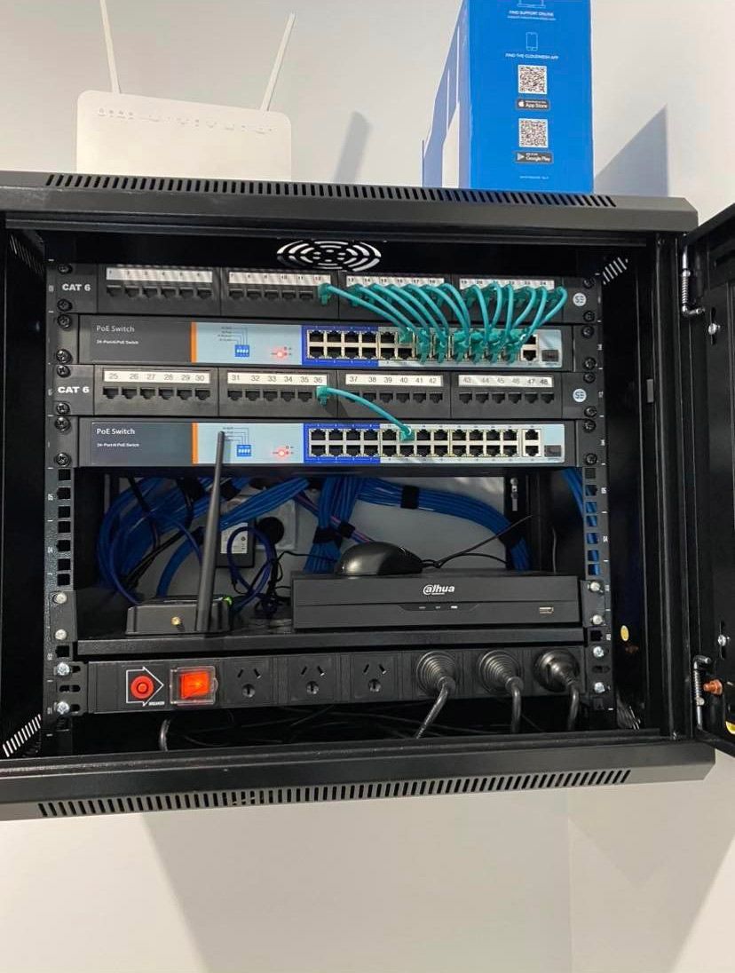 A Server Rack With a Lot of Wires Coming Out of It — DGC Tech Solutions In Mareeba, QLD