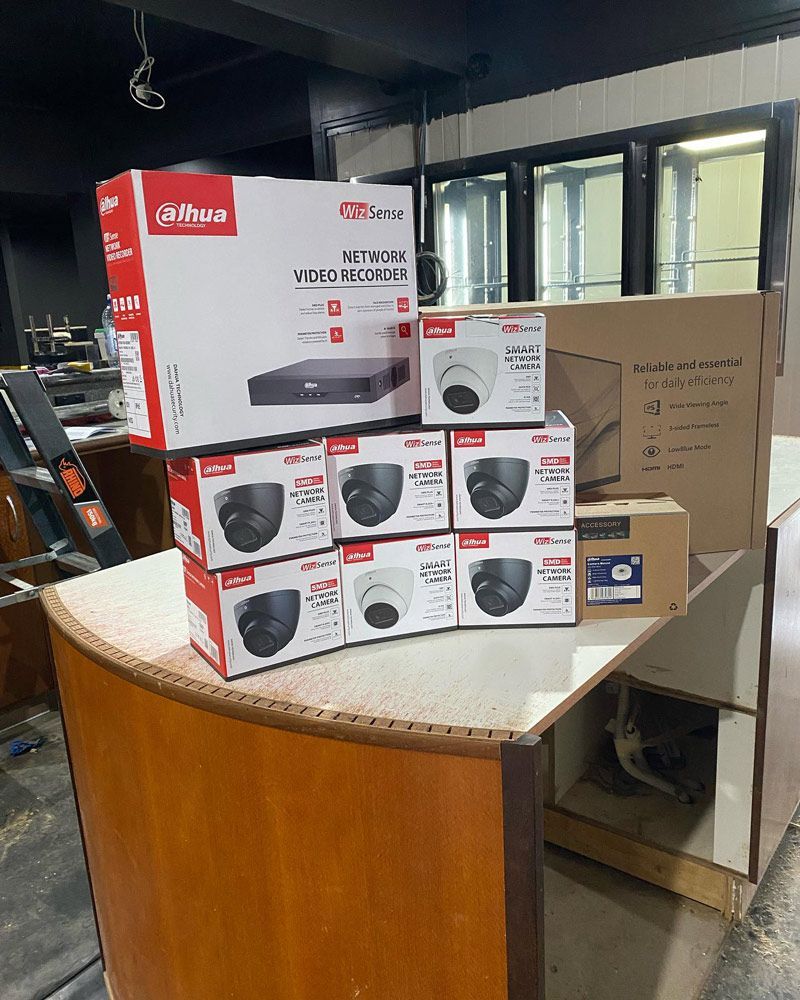 A Bunch of Cameras Are Stacked on Top of Each Other on a Table — DGC Tech Solutions In Mareeba, QLD