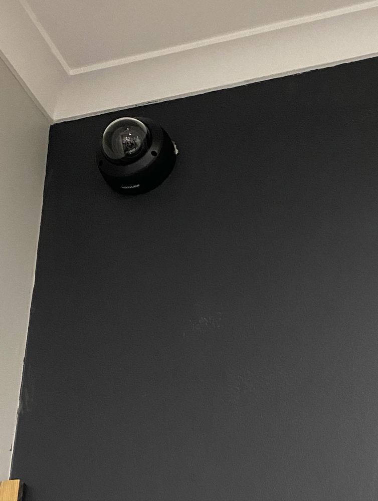 A Security Camera is Mounted to the Ceiling of a Building — DGC Tech Solutions In Mareeba, QLD