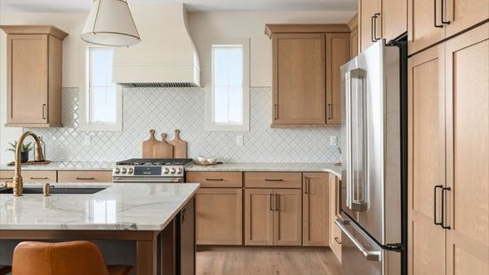 A kitchen with wooden cabinets and stainless steel appliances.