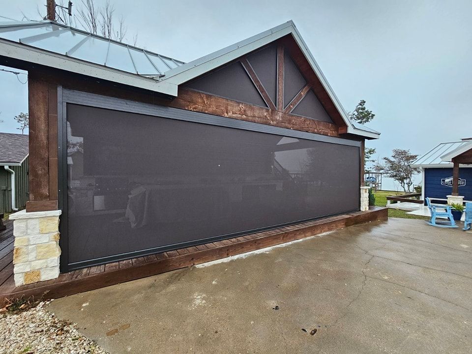 There is a large screen on the side of a building.