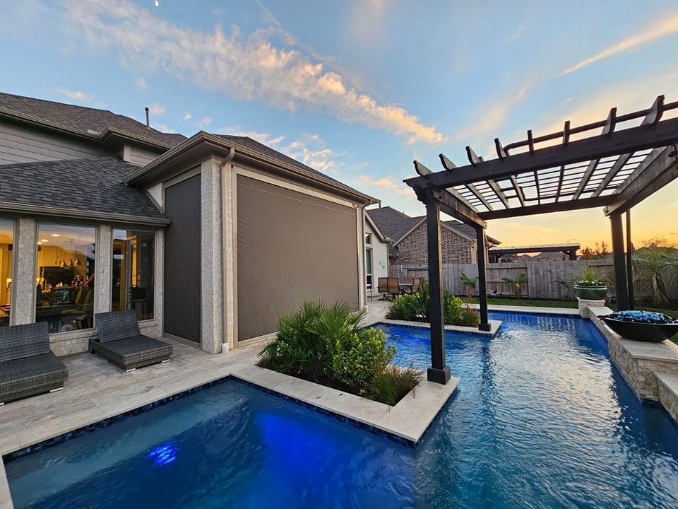 A large swimming pool with a pergola in the backyard of a house.