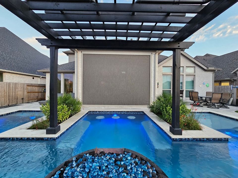 A large swimming pool with a pergola over it