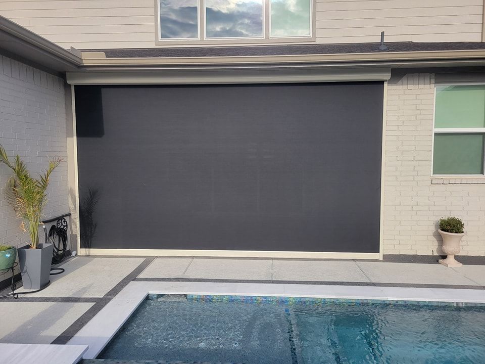 There is a swimming pool in the backyard of a house.