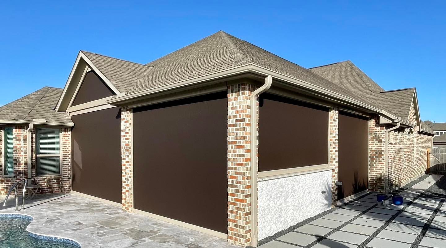 A house with a lot of windows and a brick wall.