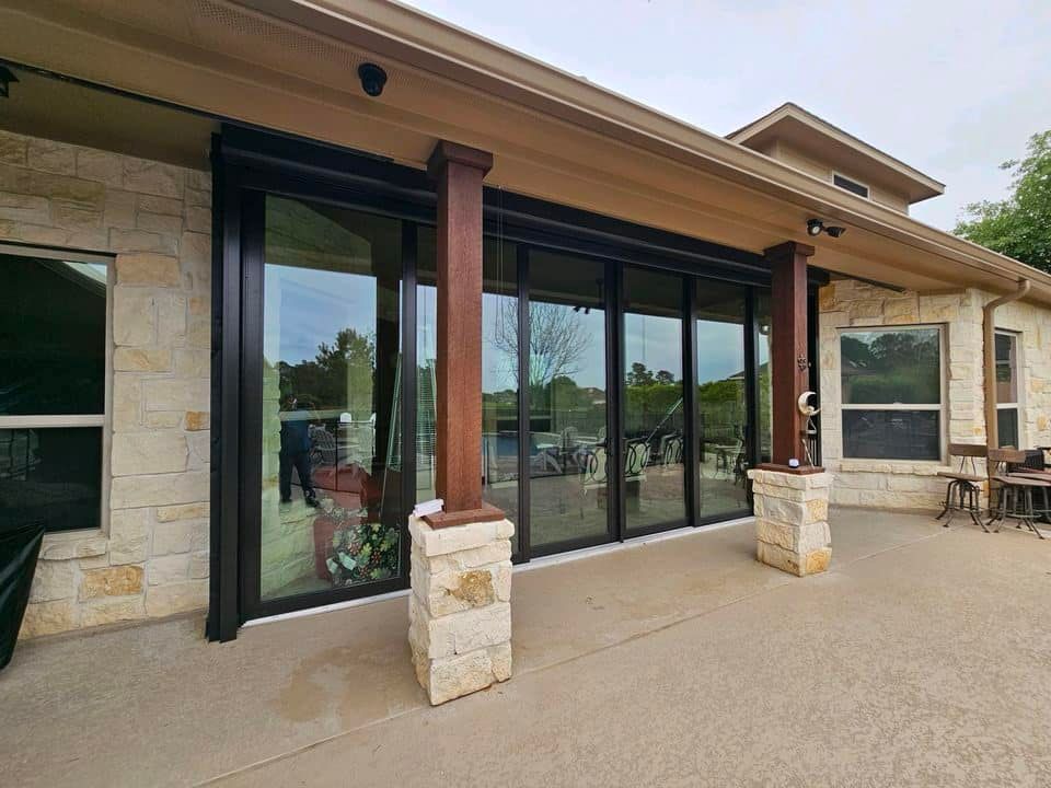 A large house with a patio and sliding glass doors.