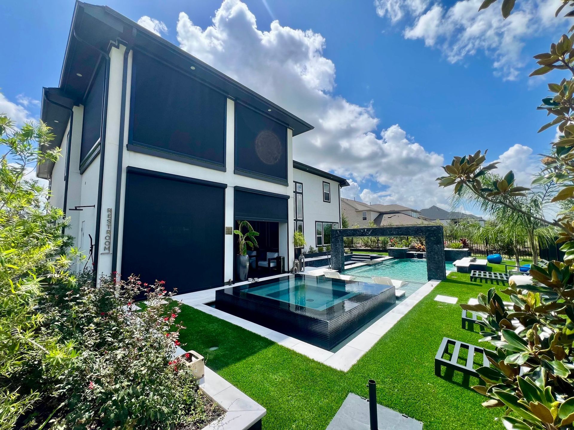 Modern contemporaty loft style house with green lawn 3d render surrounded by tropical nature, sunlig