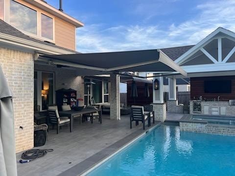 There is a large swimming pool in the backyard of a house.