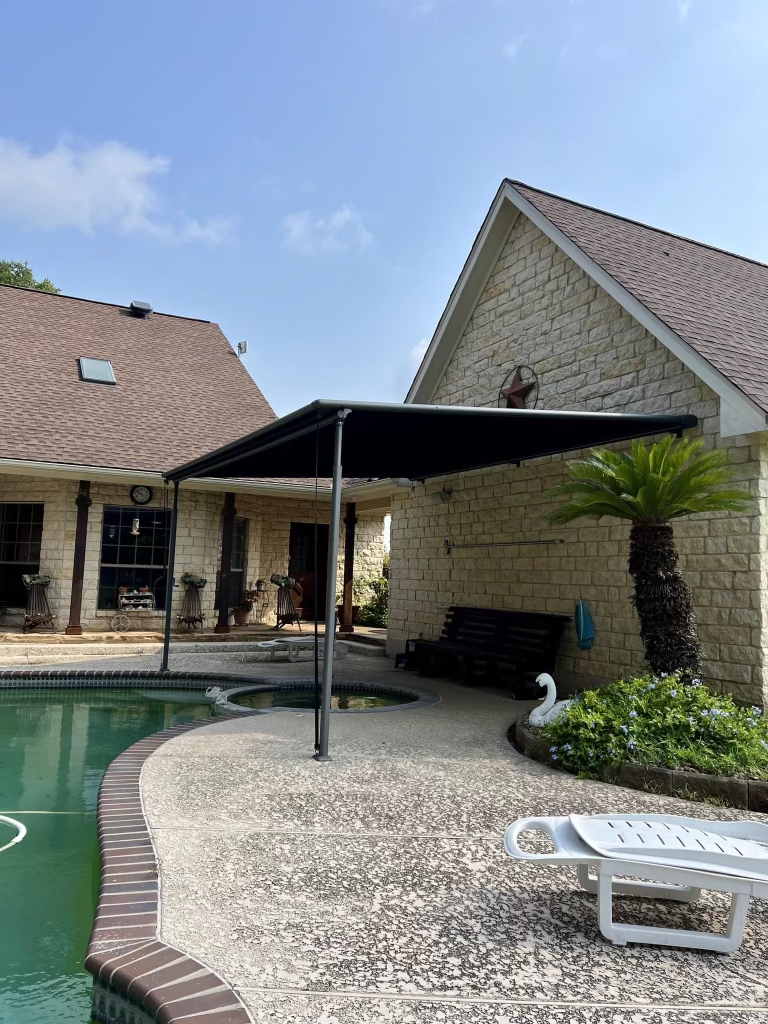 A house with a swimming pool and a canopy over it.