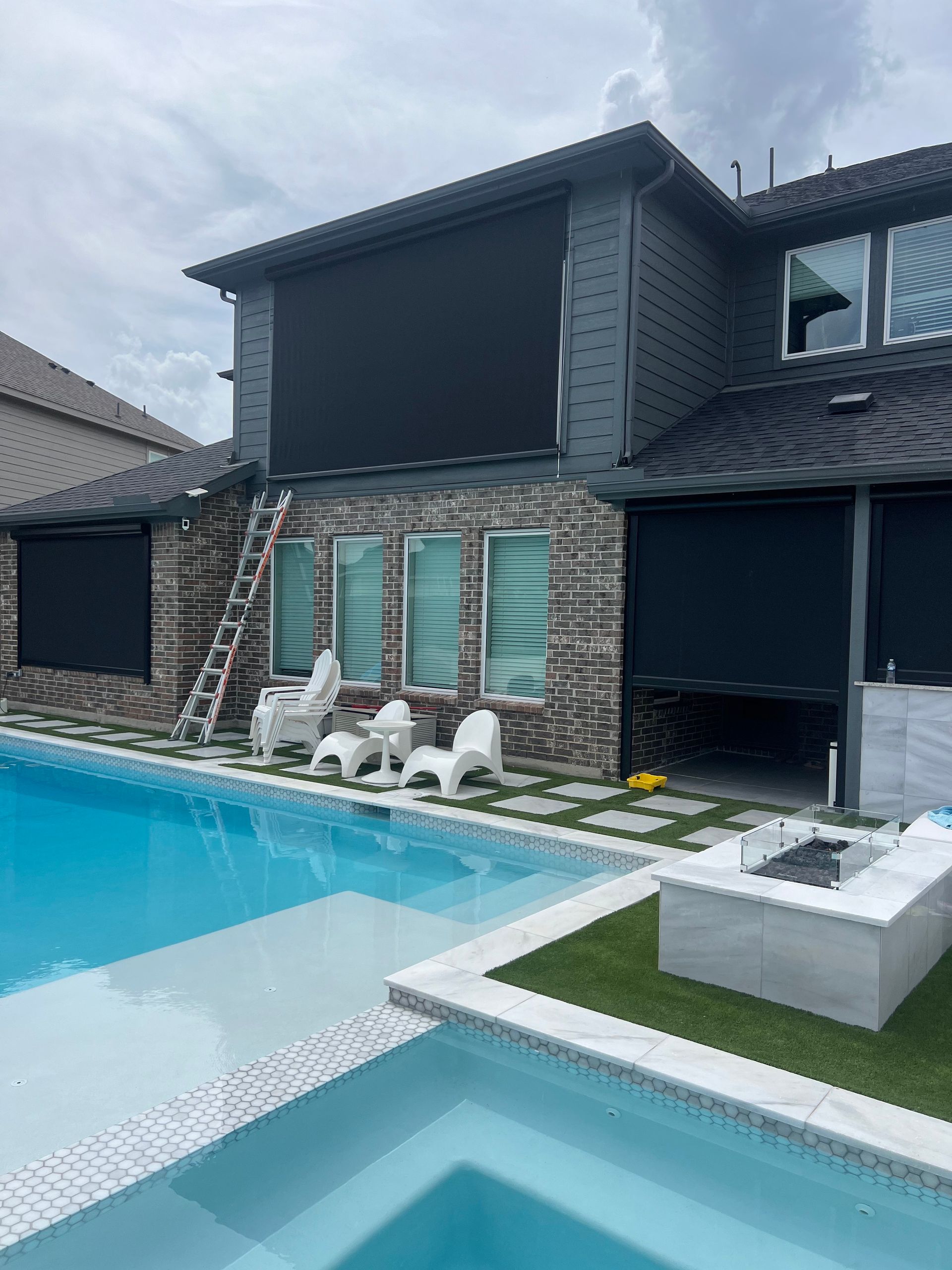 A large house with a swimming pool in front of it.