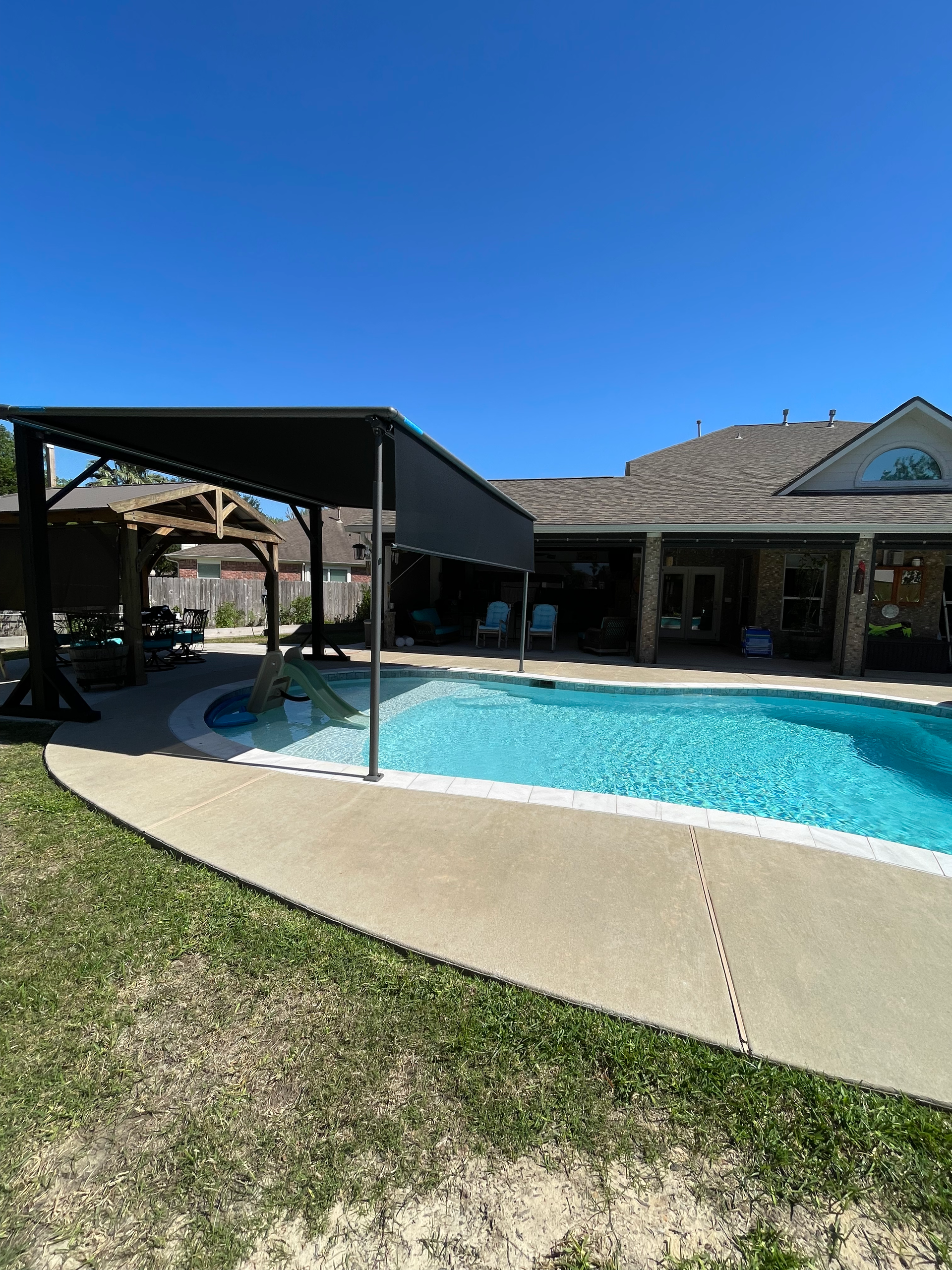 A large swimming pool in the backyard of a house