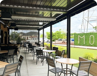 large swimming pool in the backyard of a house with motorized patio shades texas