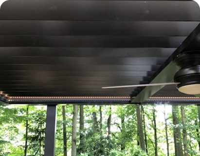 large swimming pool in the backyard of a house with motorized patio shades texas