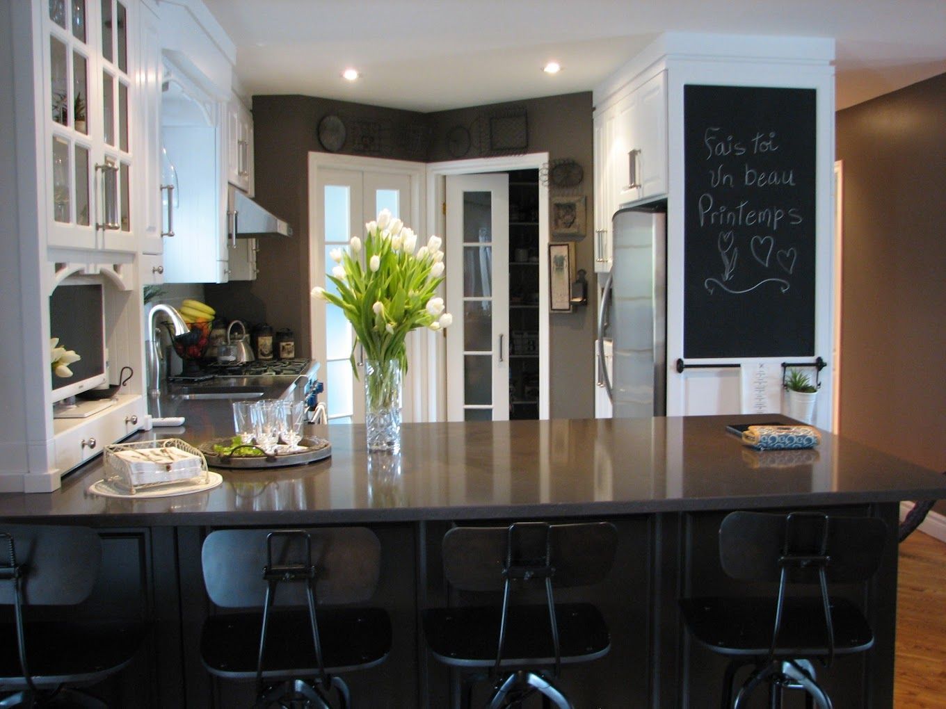 Une cuisine avec un tableau au mur qui dit 