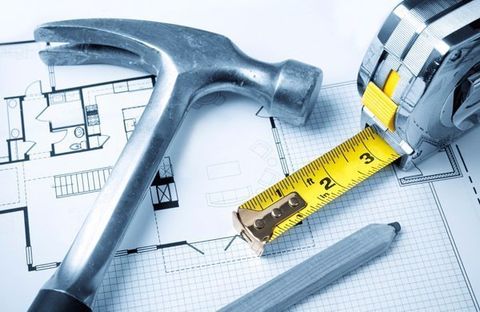 hammer, tape measure and home plans