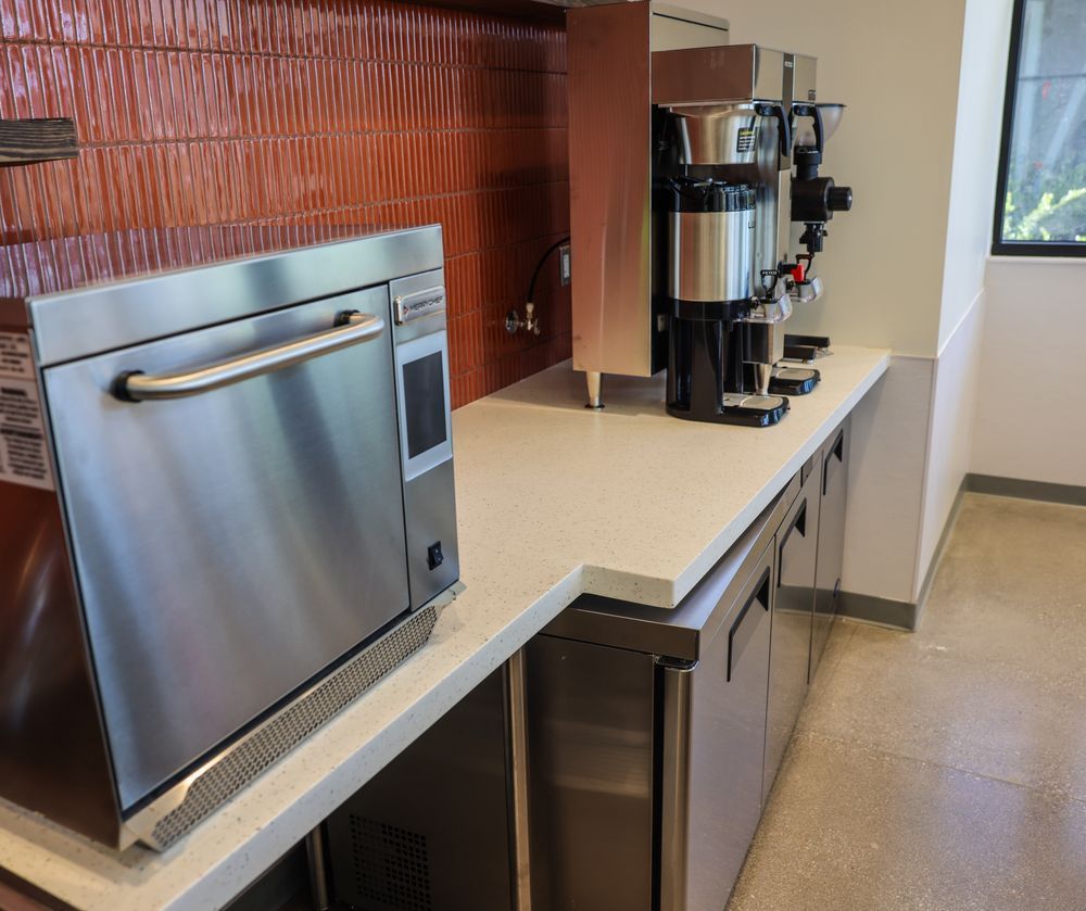 A kitchen with stainless steel appliances and a microwave oven