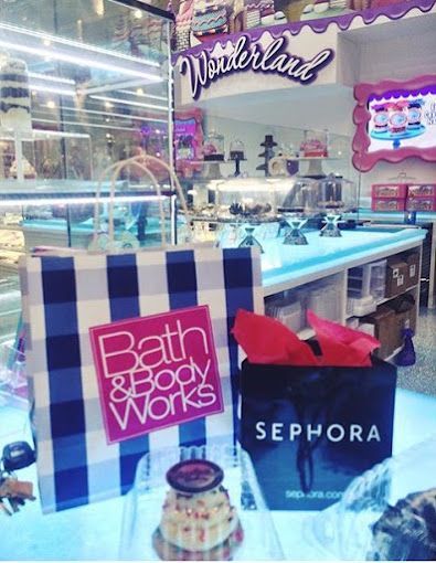 A bath and body works bag sits next to a sephora bag