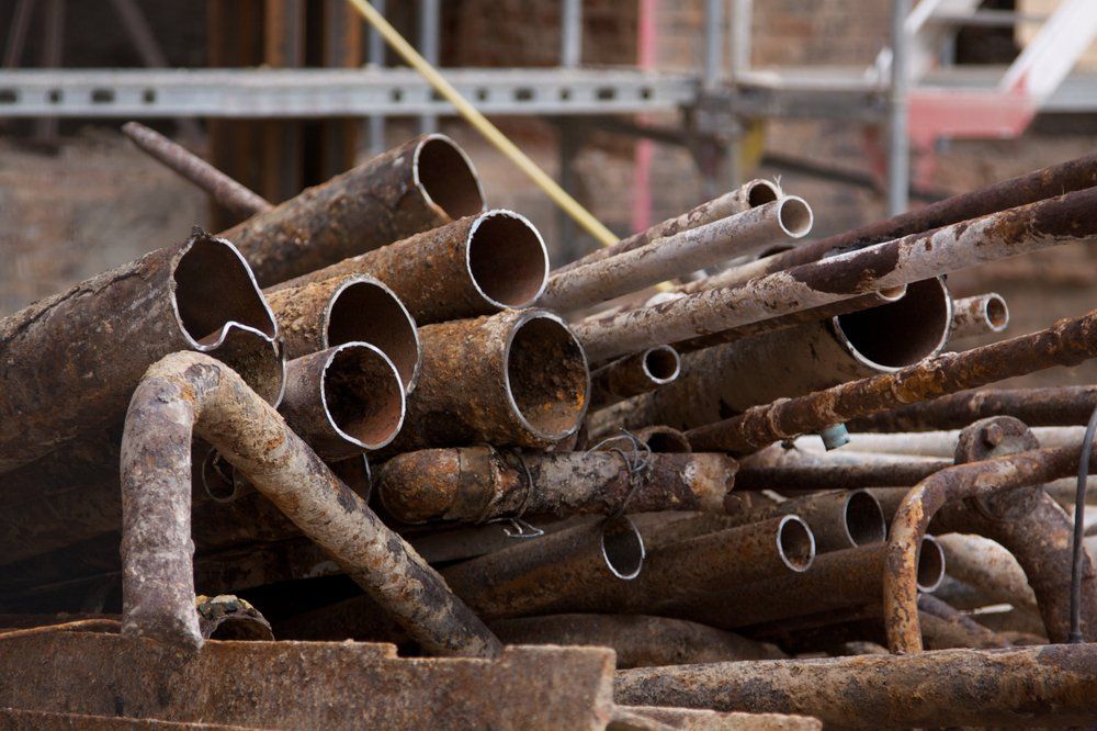 Old, Toxic Lead Pipes On A Construction Site — Independent Scrap Metal in South Lismore, NSW