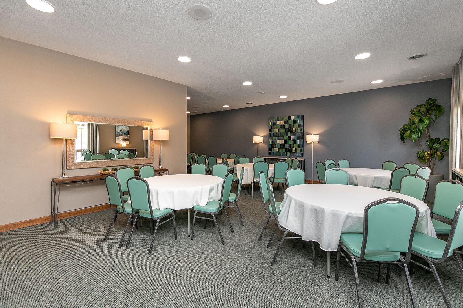 A large room with tables and chairs set up for a banquet.