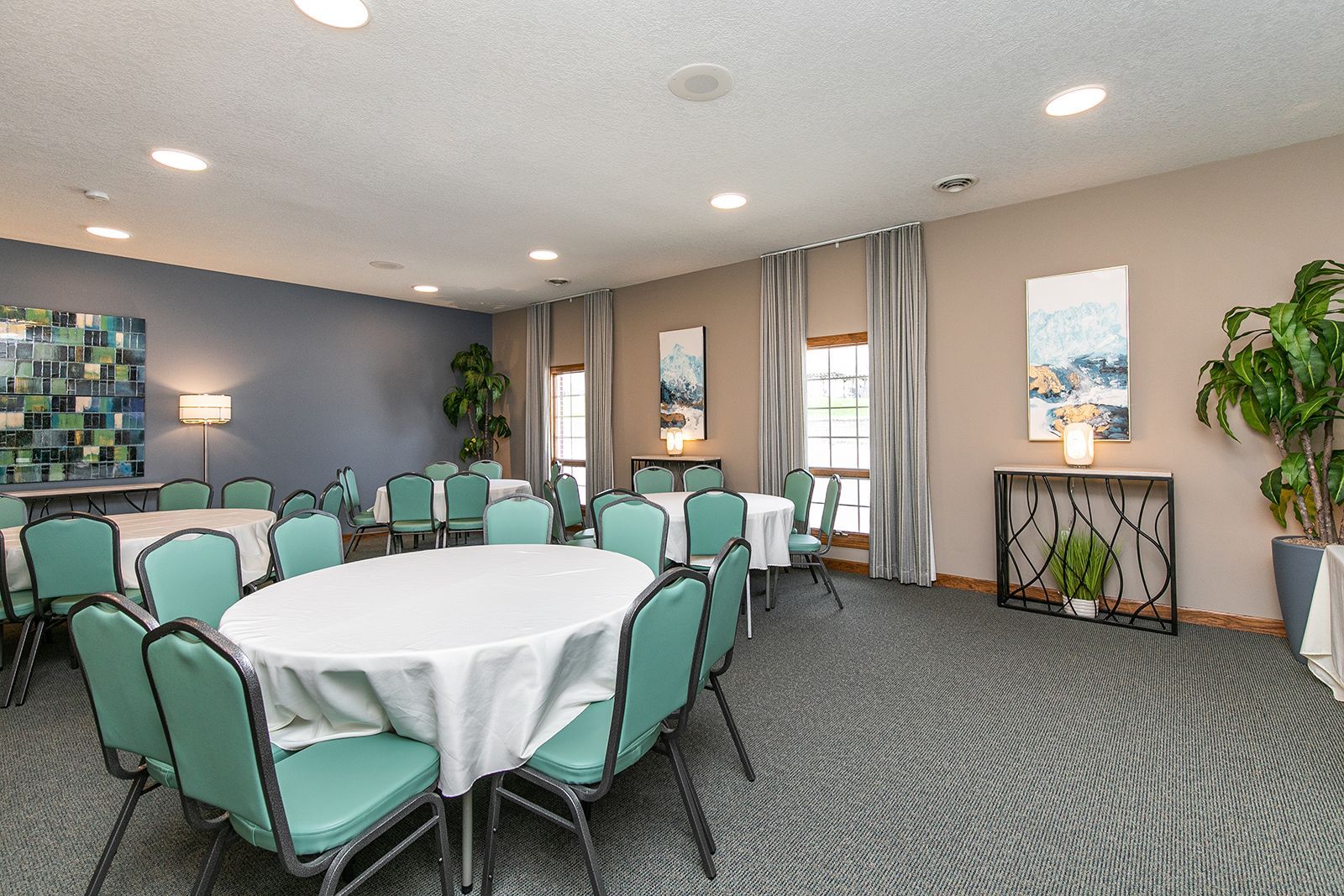A large room with tables and chairs set up for a banquet.