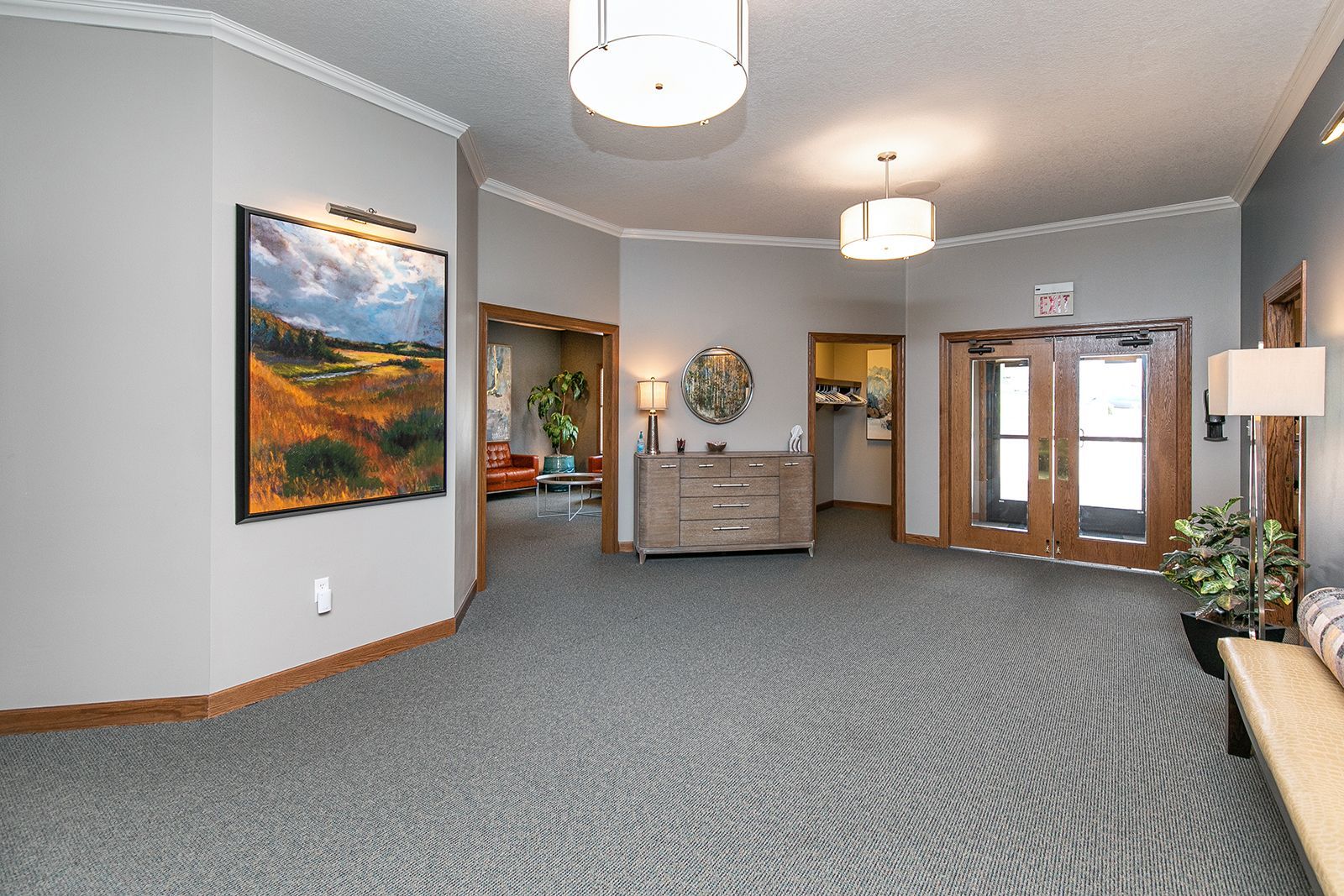 A large room with a couch and a painting on the wall.