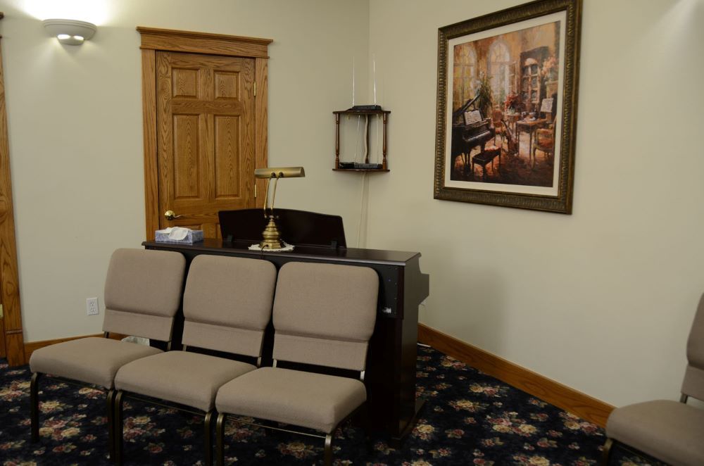 Rows of chairs are lined up in a large room.