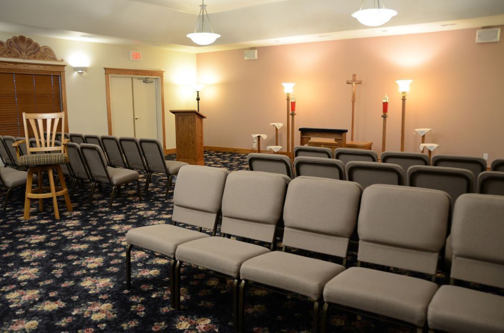 A room with rows of chairs and a podium in it