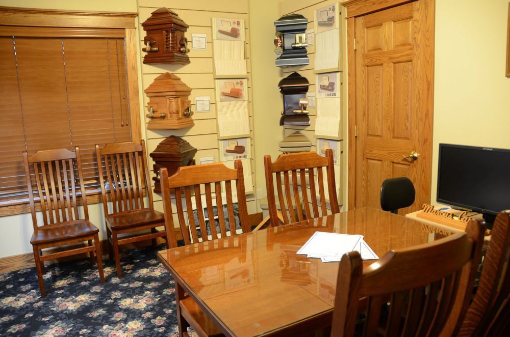 A room with a table and chairs and a computer