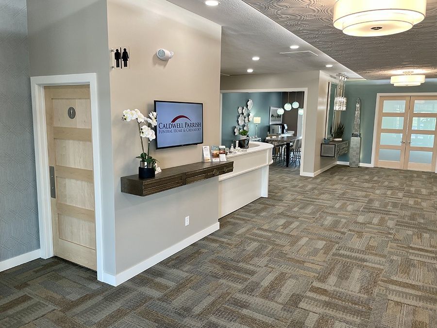 There is a television on the wall in the middle of the room.