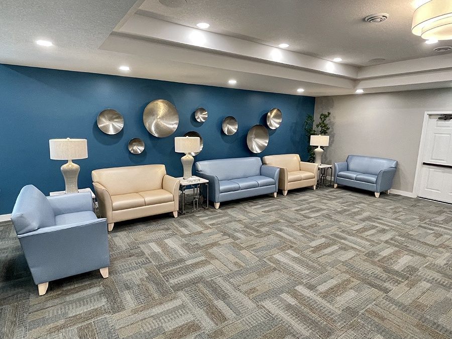 There are a lot of chairs and couches in this room.