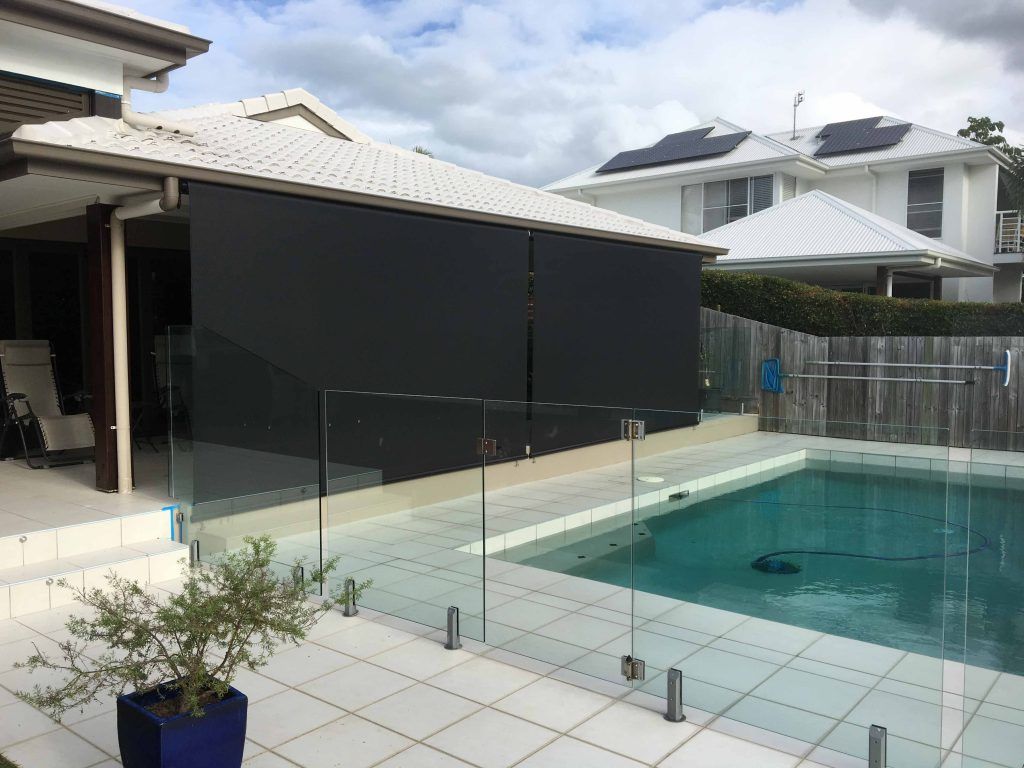 black outdoor blinds near pool