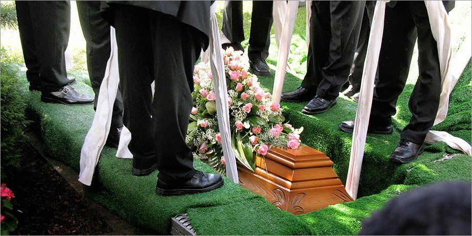 A coffin being lowered into a grave