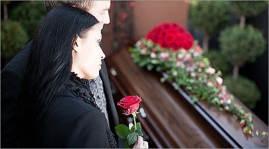 Mourners beside a casket