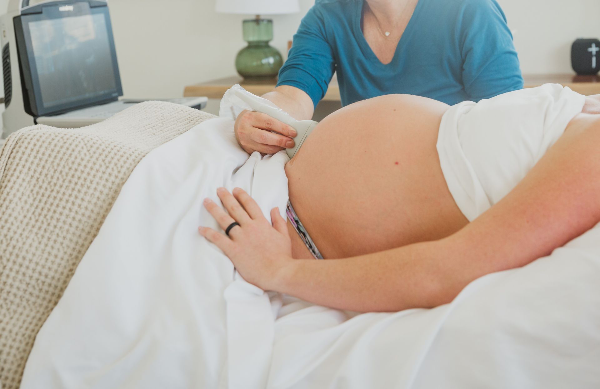 A woman is getting a massage on her stomach while laying on a table.