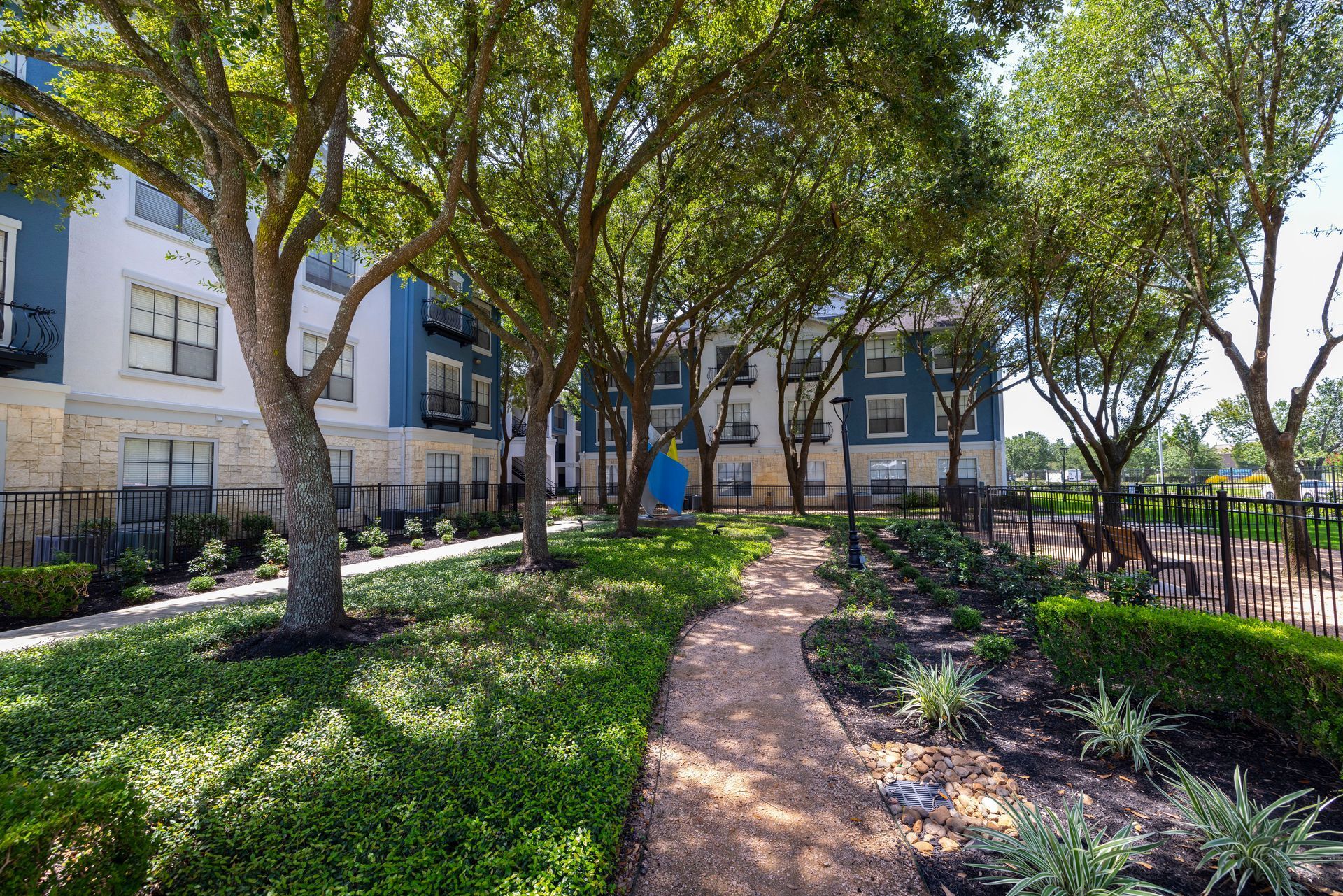 A path leading to a building with trees in front of it.