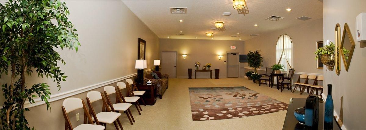 A large room with a lot of chairs and a plant.