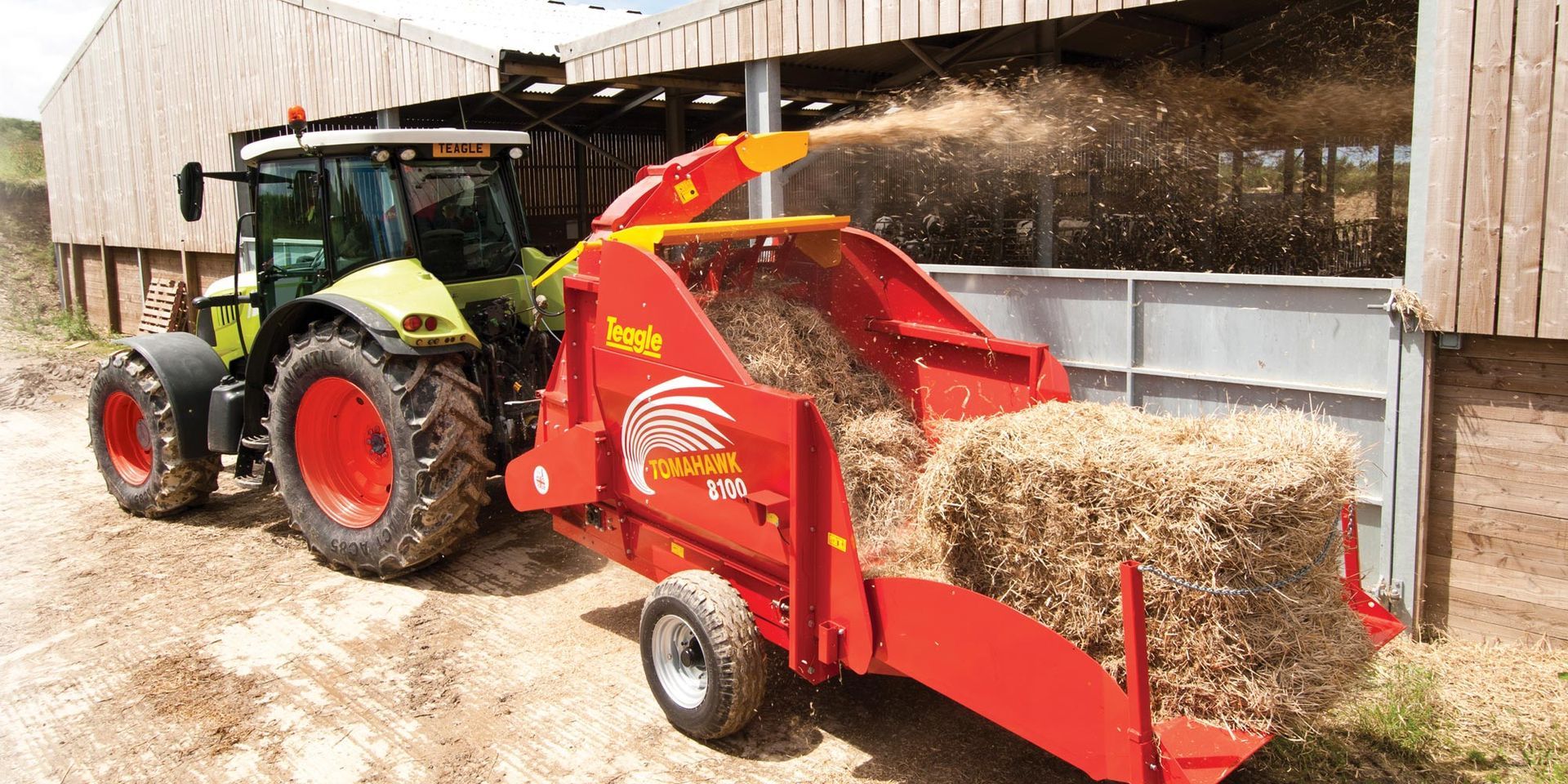A tractor is pulling a machine that is cutting hay.