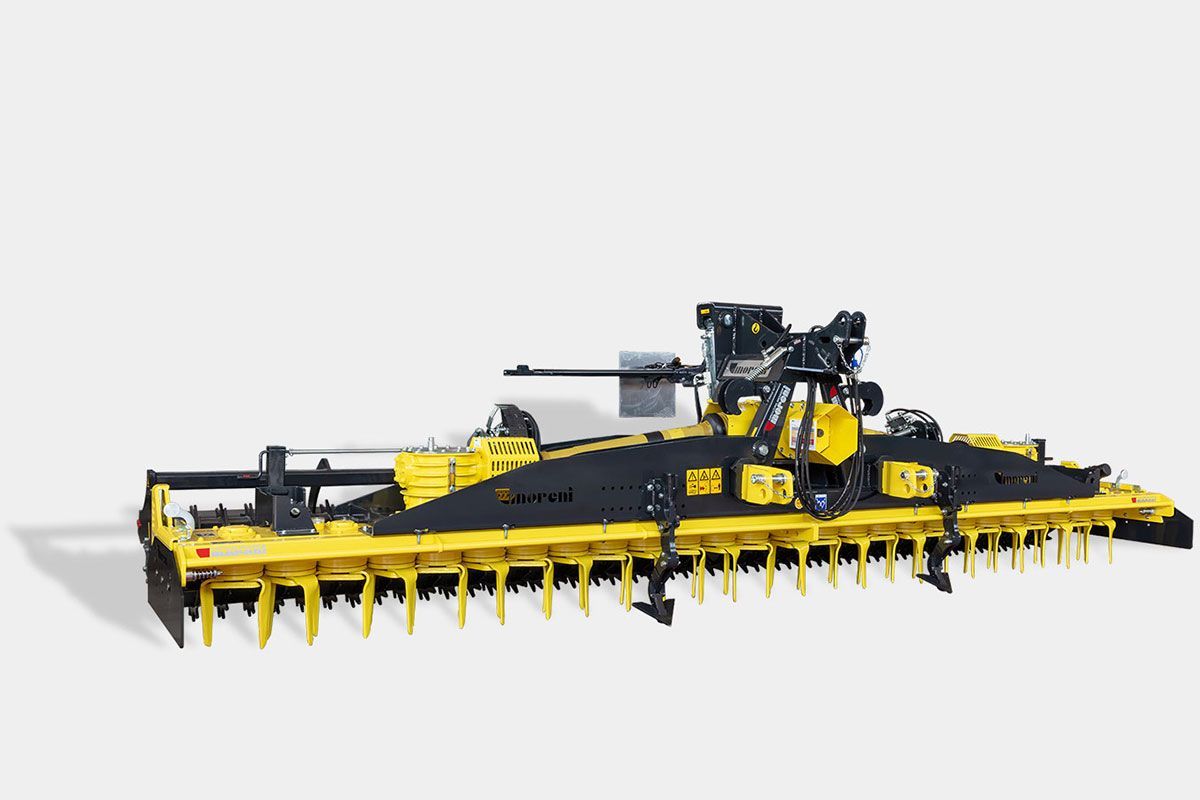 A yellow and black power harrow is sitting on a white surface.