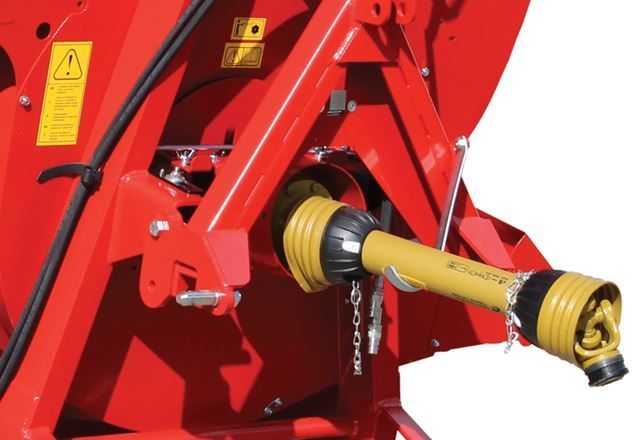 A red machine with a yellow warning sign on it