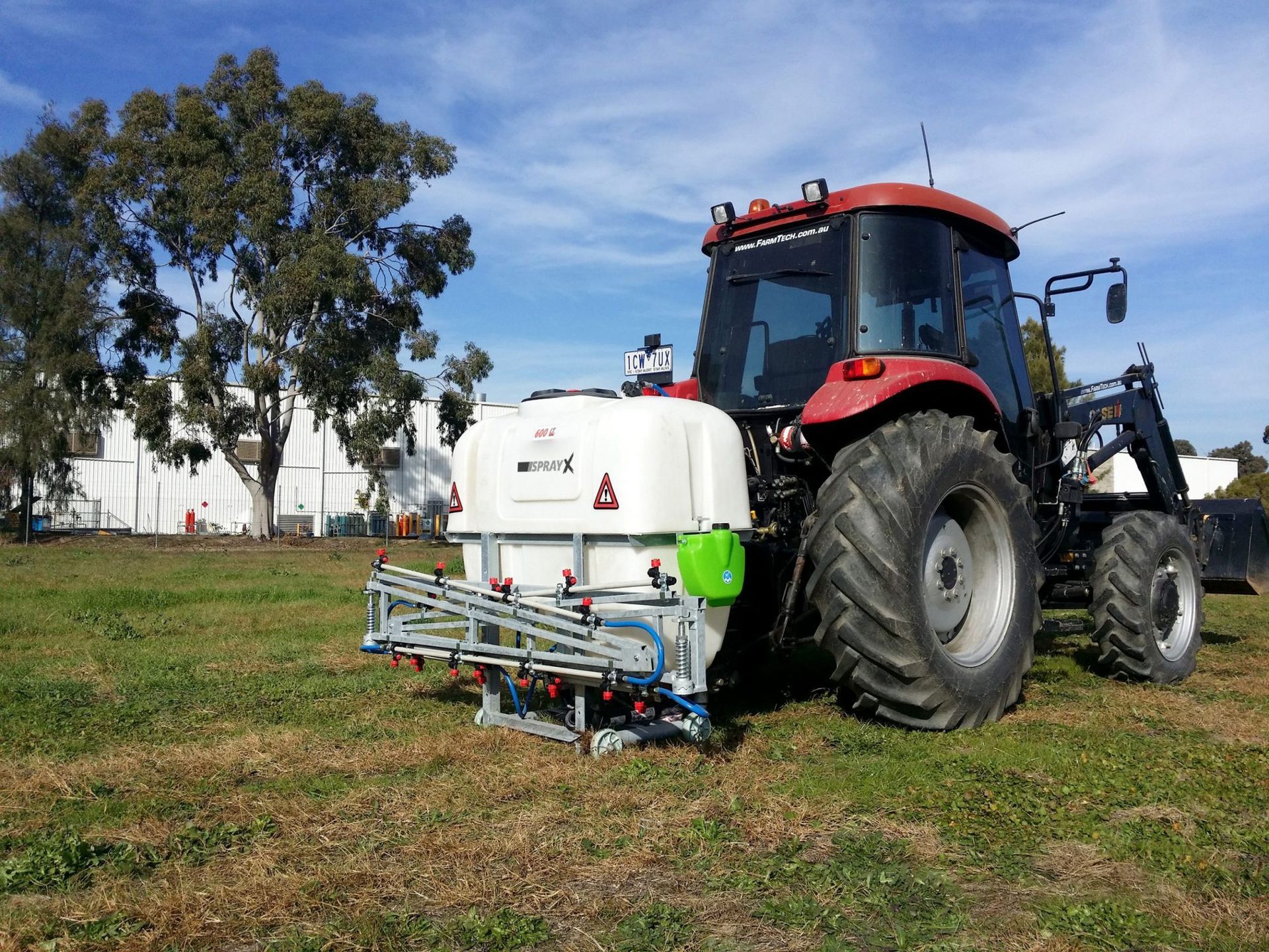 A line drawing of a tractor on a gray background.