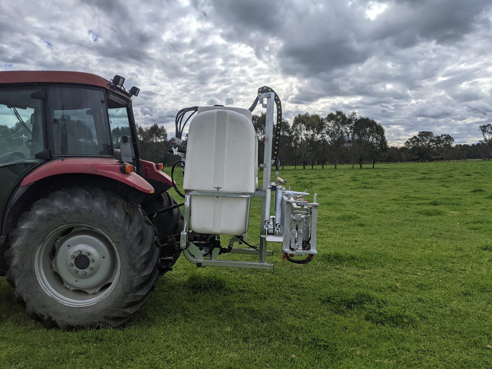 A line drawing of a tractor on a gray background.