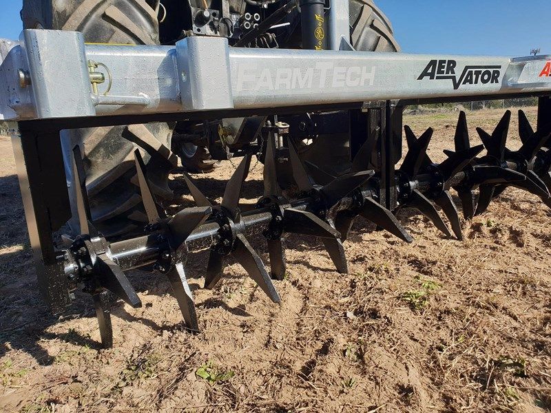 A tractor with a farmtech aerator attached to it