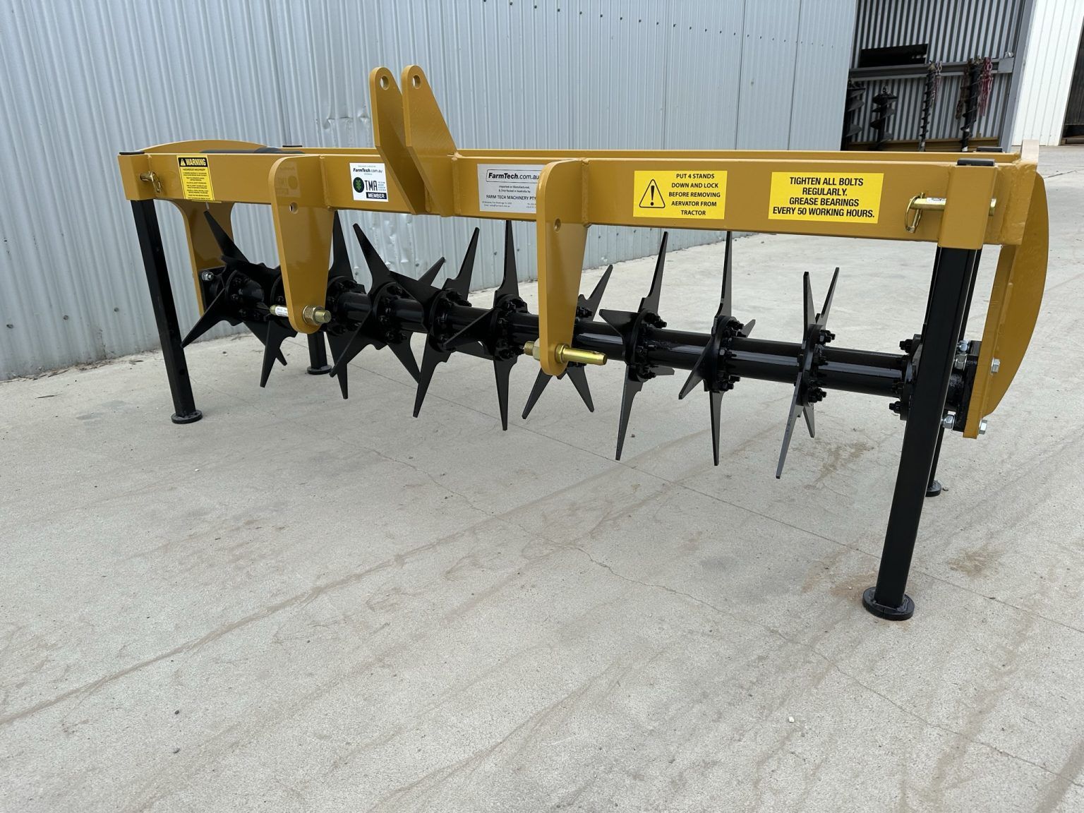 A machine with a lot of blades is sitting on the ground