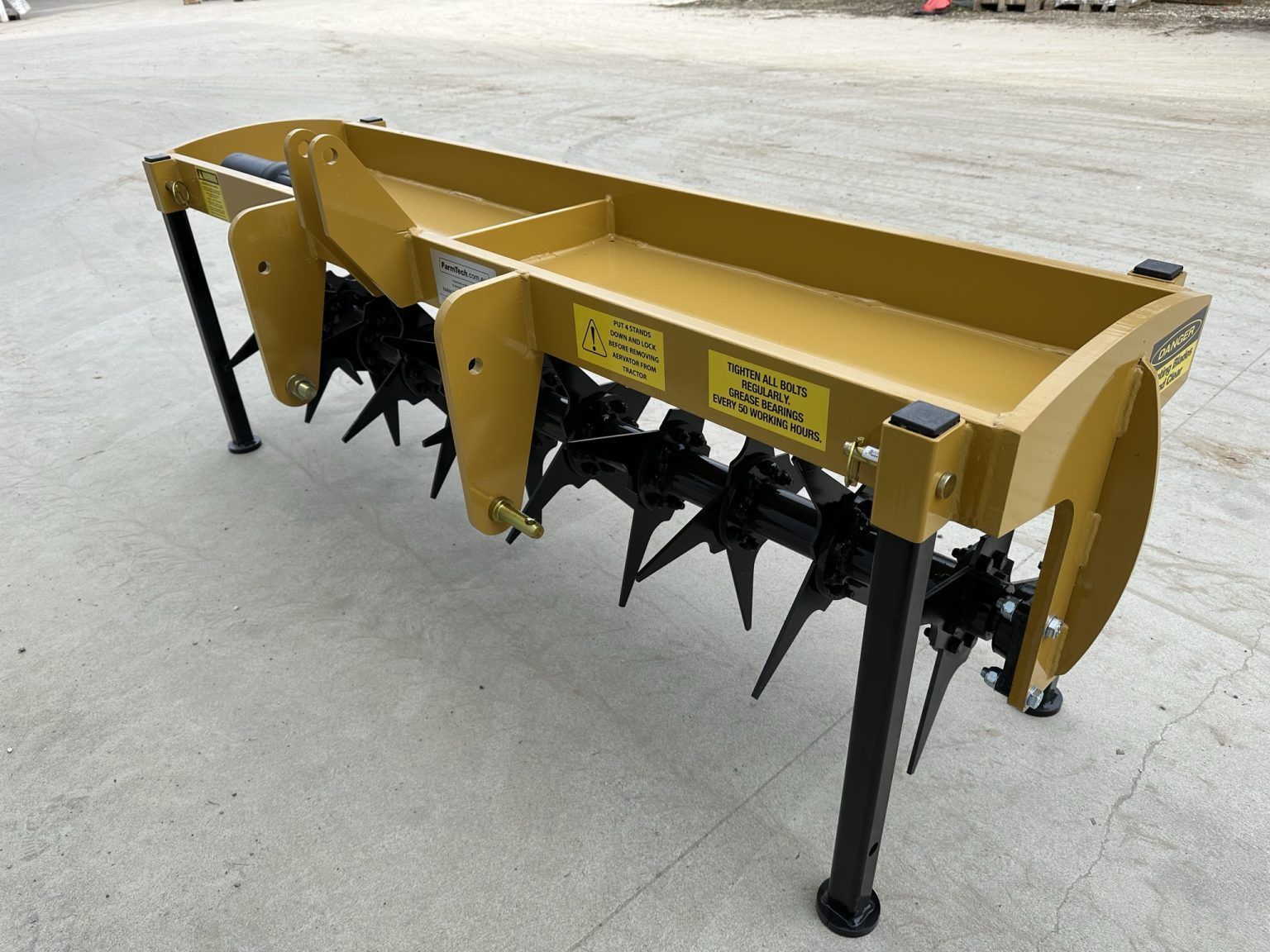 A yellow and black machine is sitting on the ground