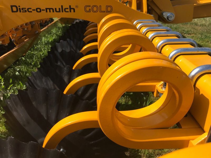 A close up of a yellow disc-o-mulch gold machine