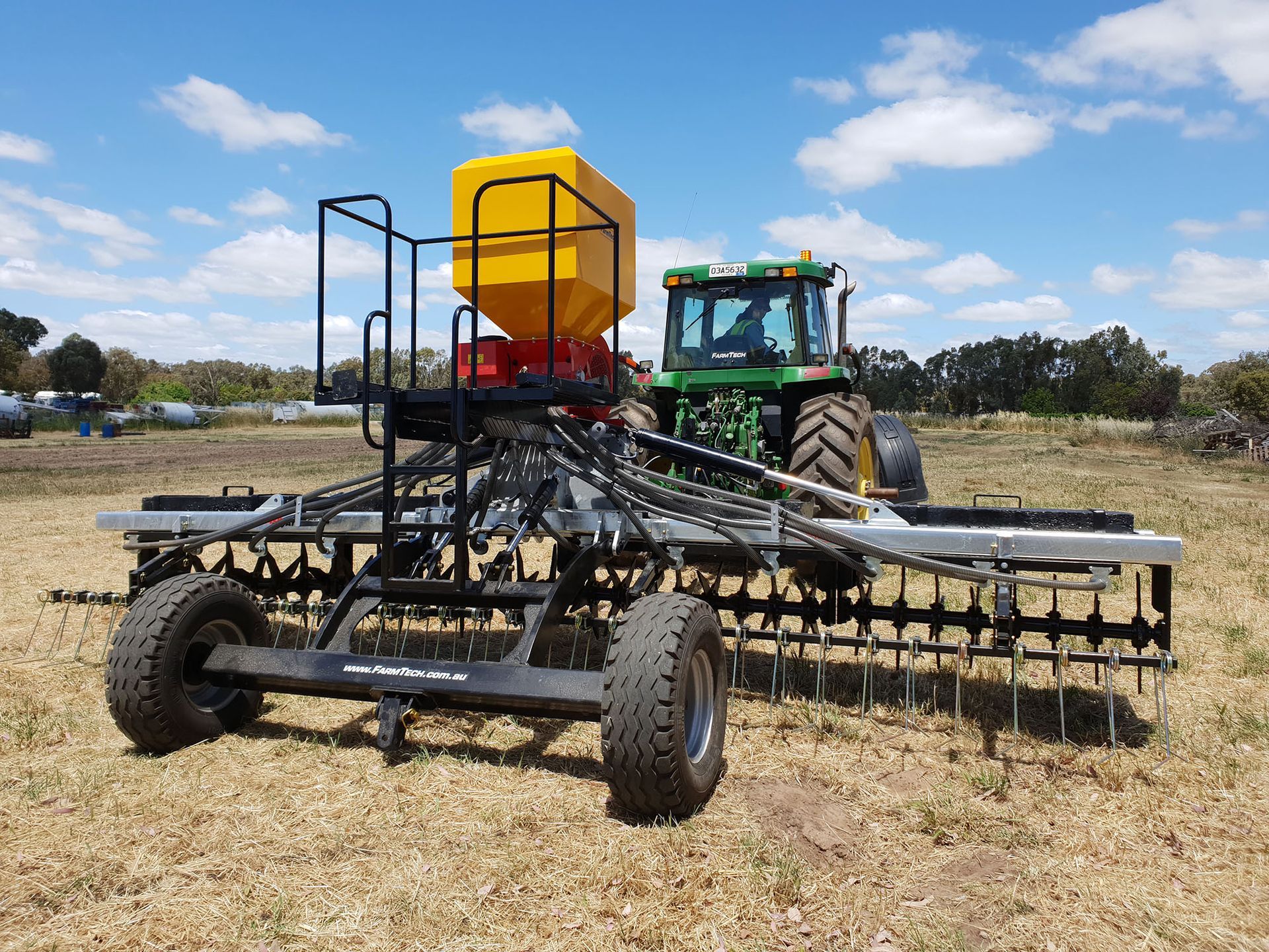 A tractor is aerating a field.