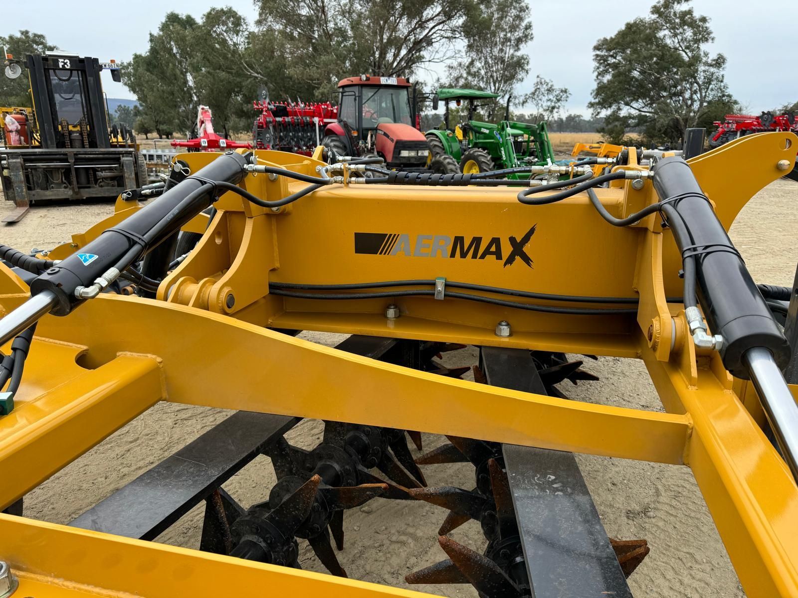 A tractor with a farmtech aerator attached to it